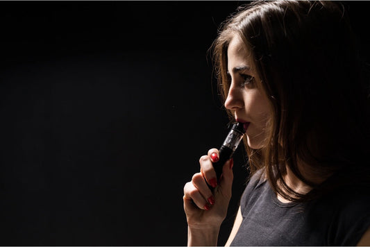 Adult using a compact pod vape device